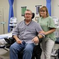 A man in a wheelchair with a woman standing beside him